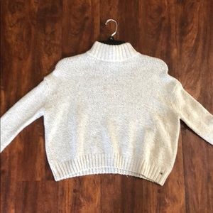 A white/cream turtleneck sweater